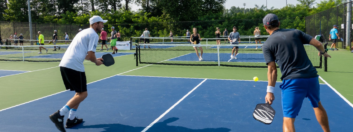 Group of pickleball players playing doubles on a sunny fathers day.