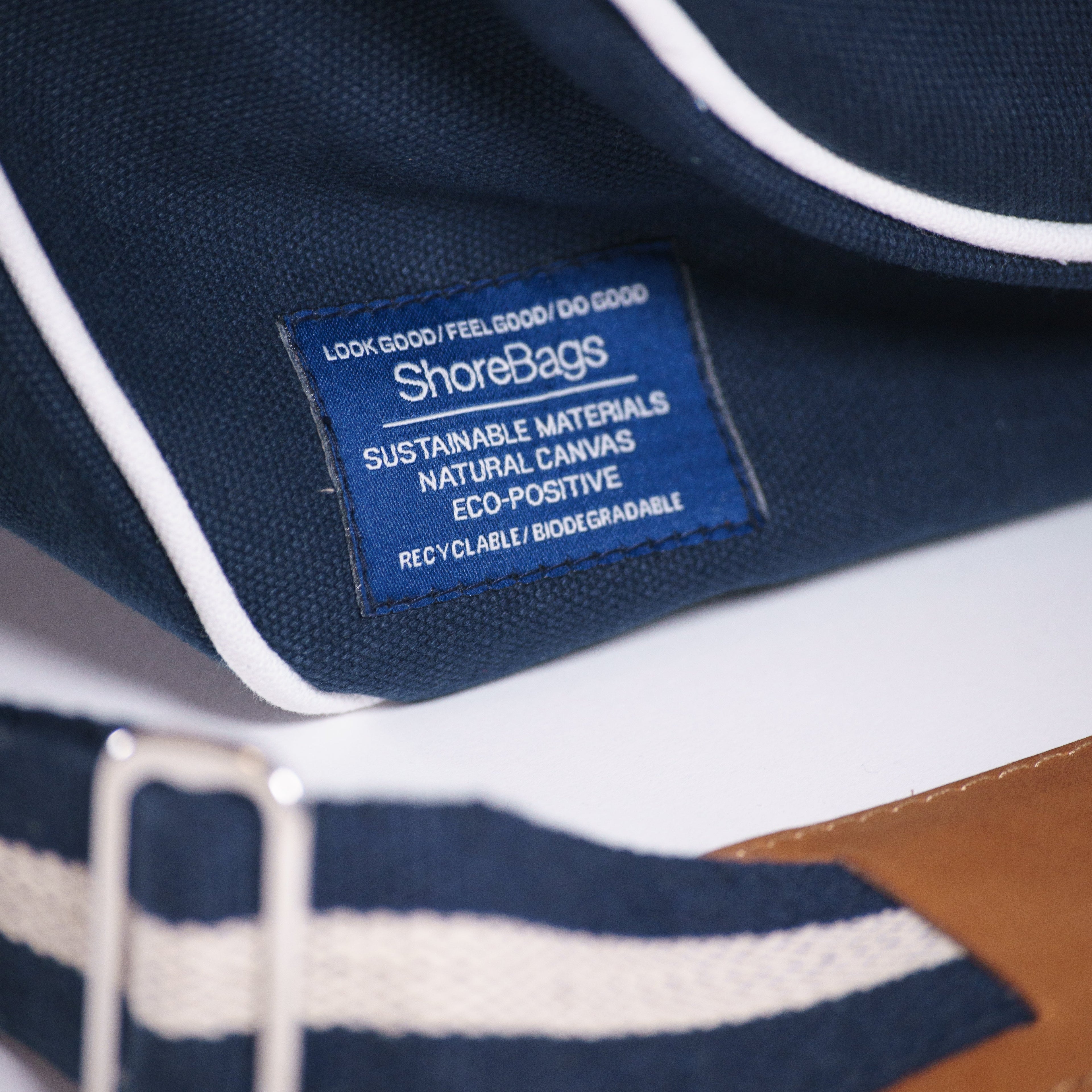 Detailed view of label on navy blue canvas pickleball bag