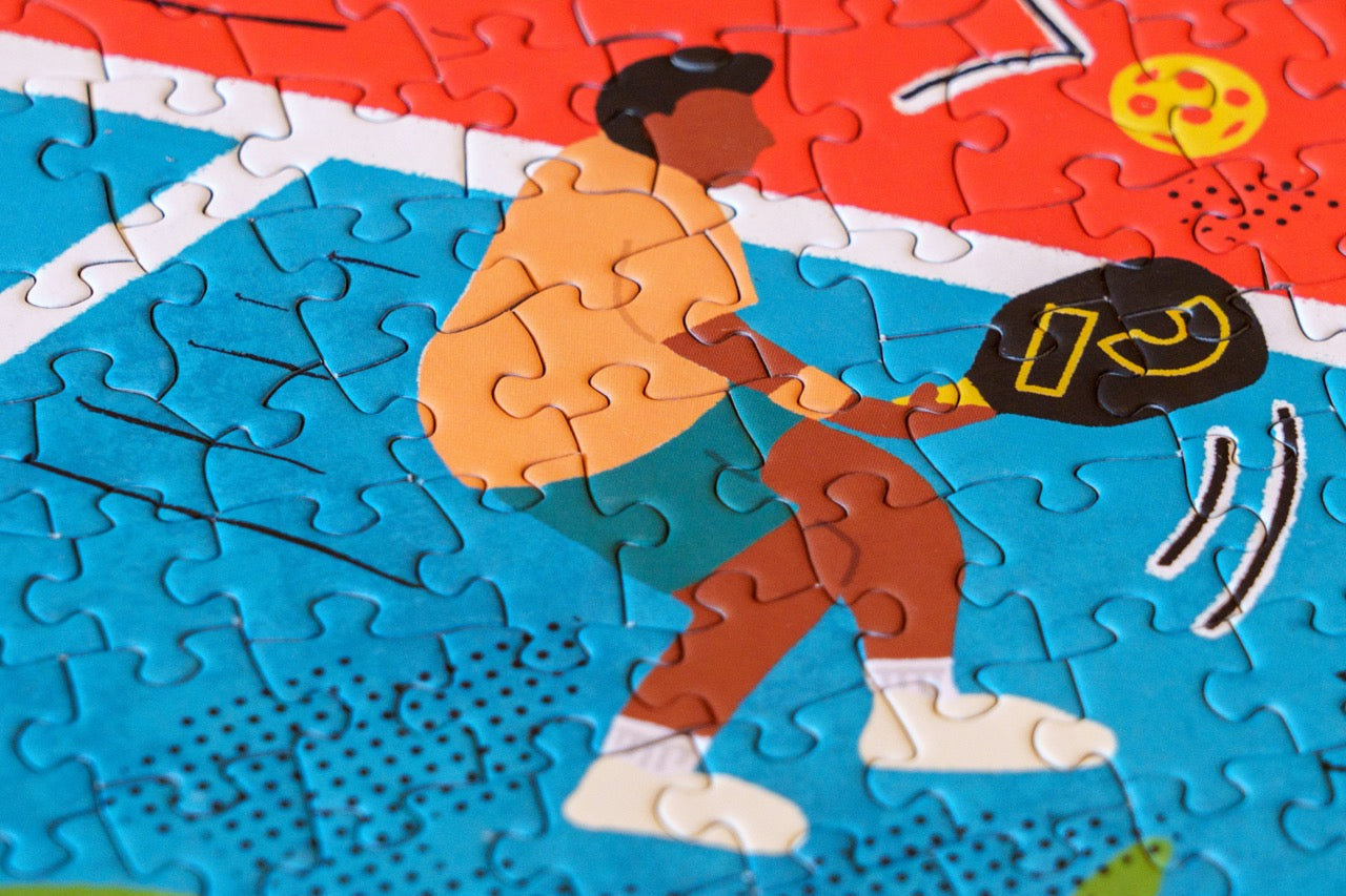 Up close of puzzle pieces that show a player from a 1,000 Piece Pickleball Jigsaw Puzzle