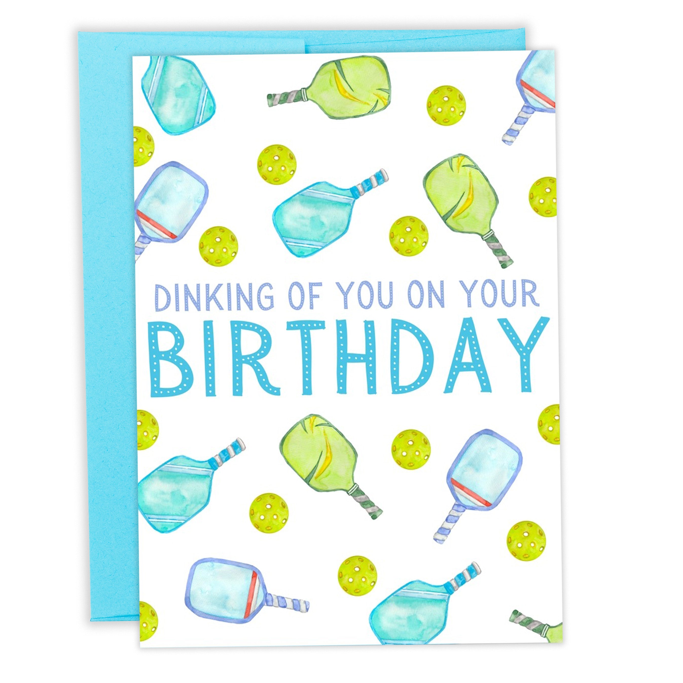 Pickleball-themed birthday card that says "Dinking Of You On Your Birthday" Greeting Card Laying Flat