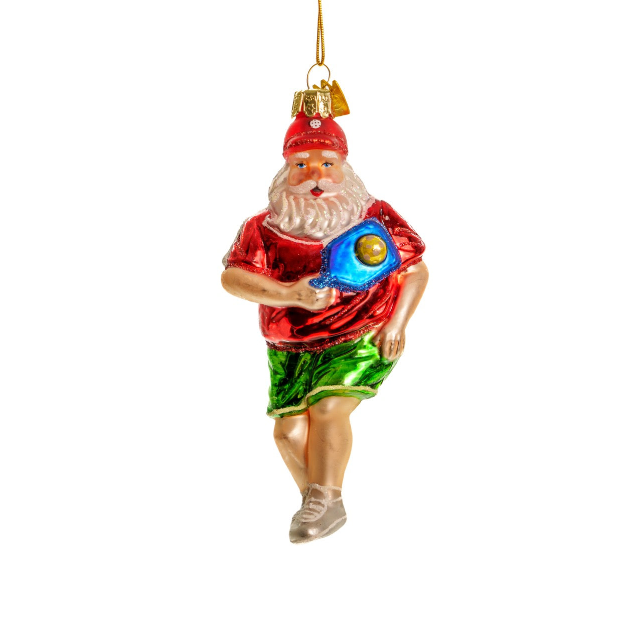 Elegant handmade glass Christmas ornament of Santa playing pickleball hanging in front of a white studio backdrop