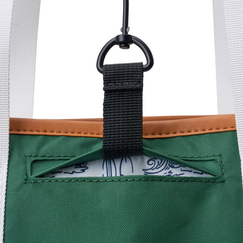 Detailed view of pocket for fence hook feature in green pickleball tote bag