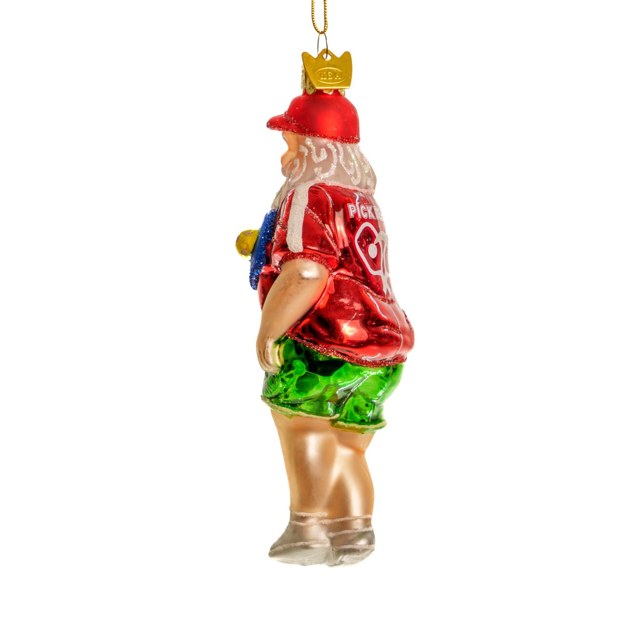 Left side of an elegant handmade glass Christmas ornament of Santa playing pickleball hanging in front of a white studio backdrop
