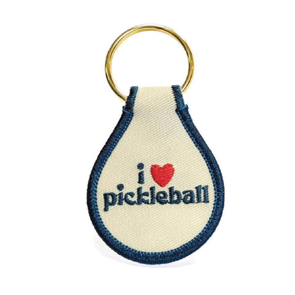 Red white and blue keychain that says "I heart pickleball" on it