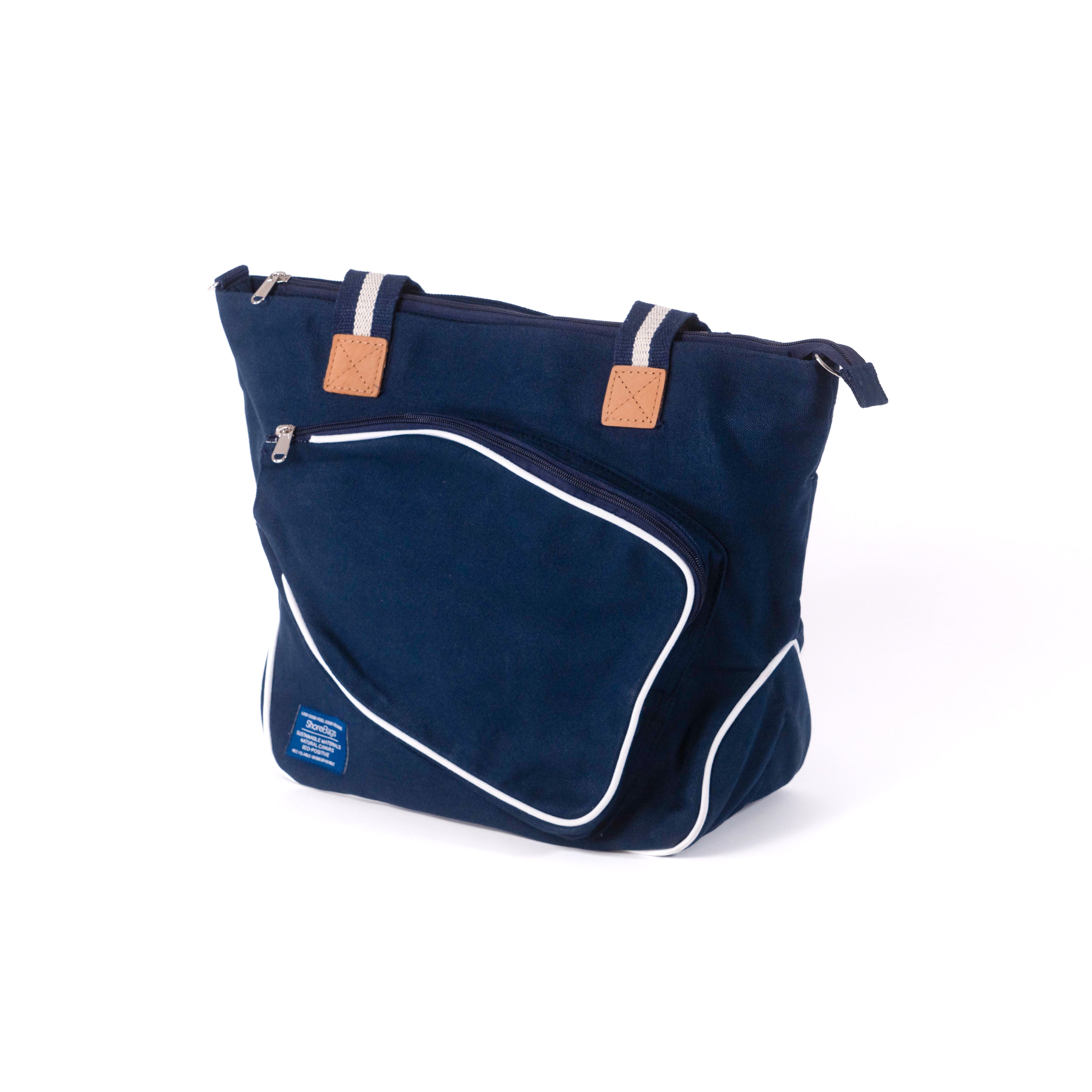Side view of navy blue canvas pickleball bag with white accents and a leather strap
