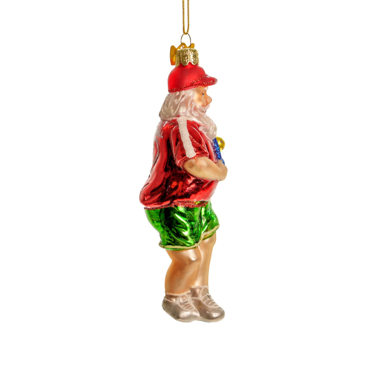 Right side of a classic handmade glass Christmas ornament of Santa playing pickleball hanging in front of a white studio backdrop