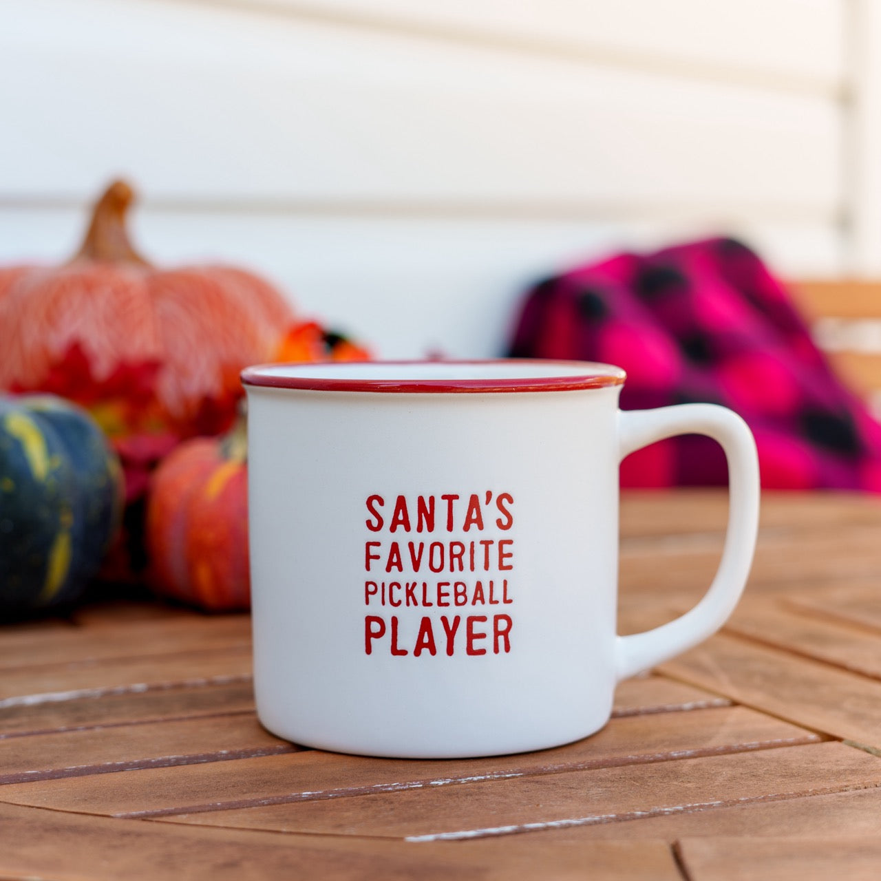 White and red ceramic coffee mug that says Santa&
