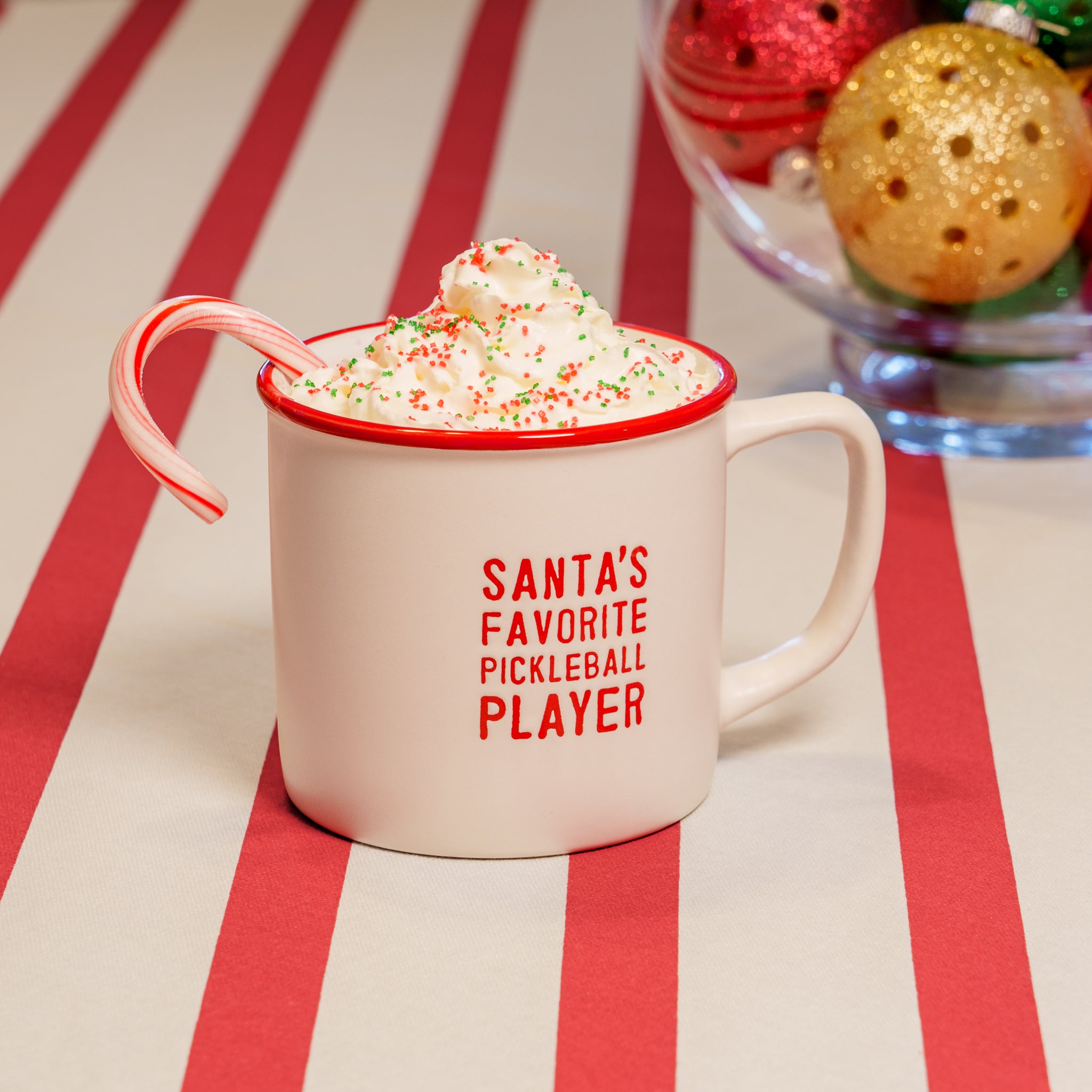 A white debossed mug that says "SANTA&