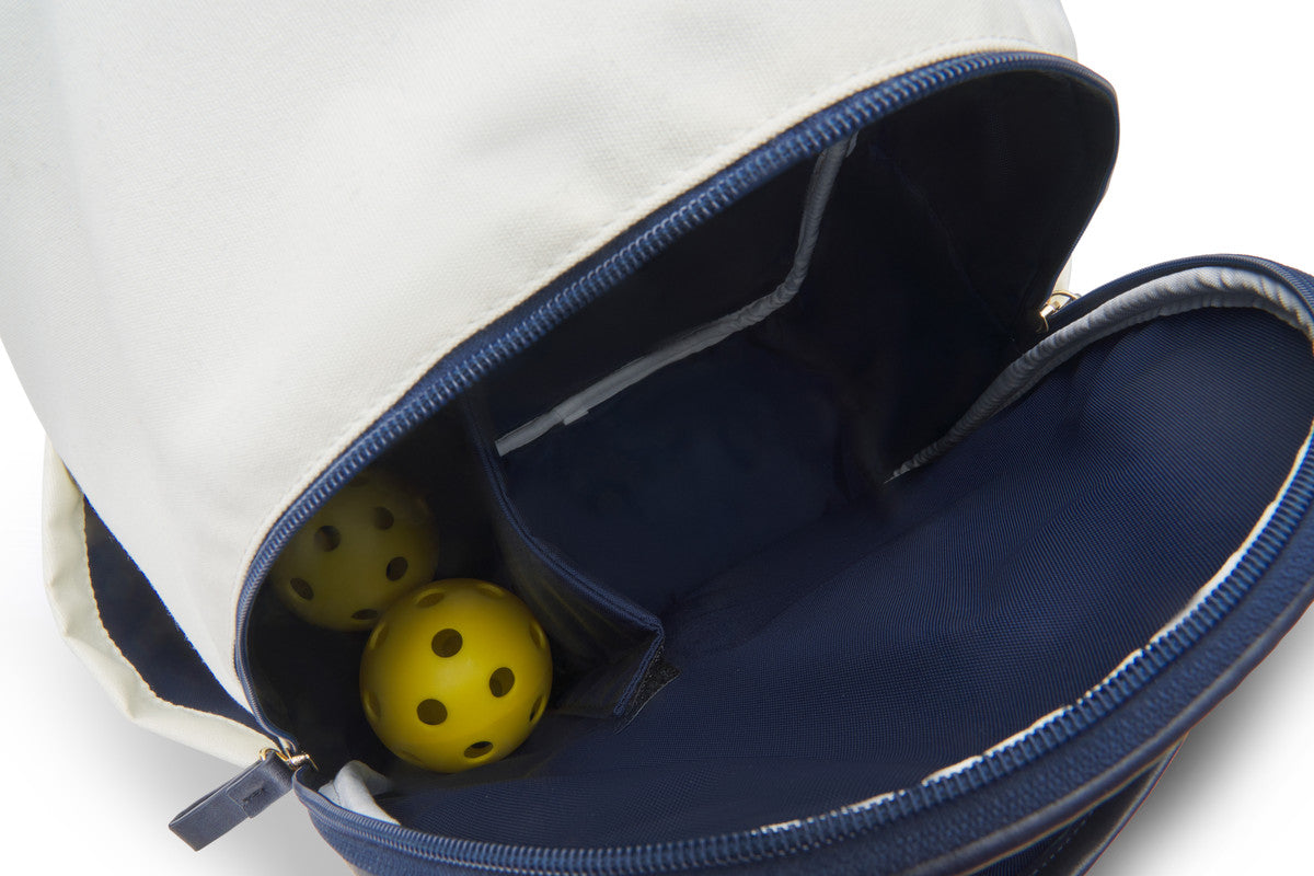 Built in ball pocket in inside of white and navy pickleball backpack