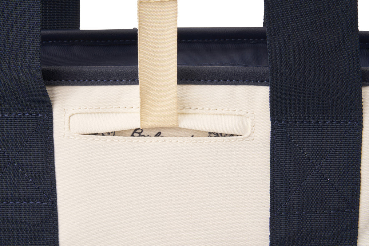 Built in pocket that holds bag hook in white and navy pickleball tote bag