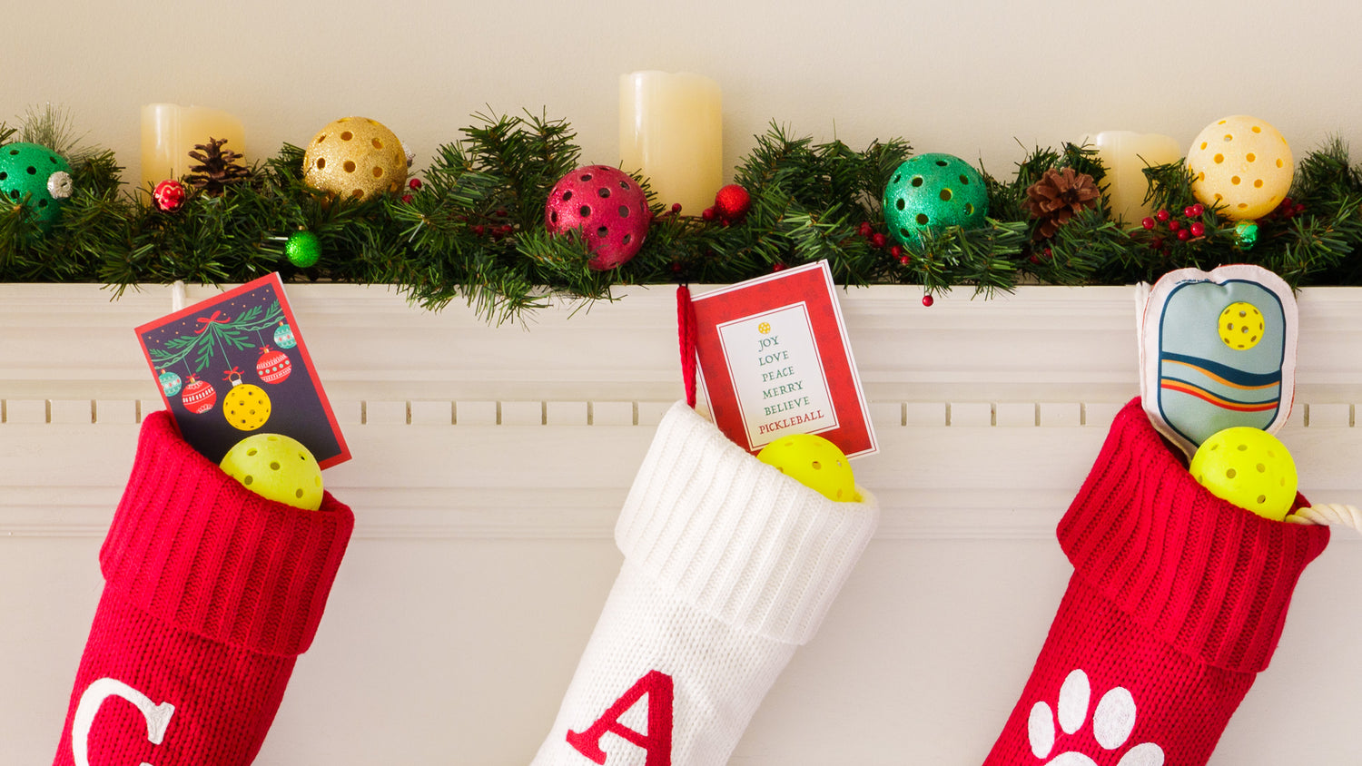 Cartoon fireplace mantle with a Christmas stocking stuffed with pickleballs and pickleball related gifts.