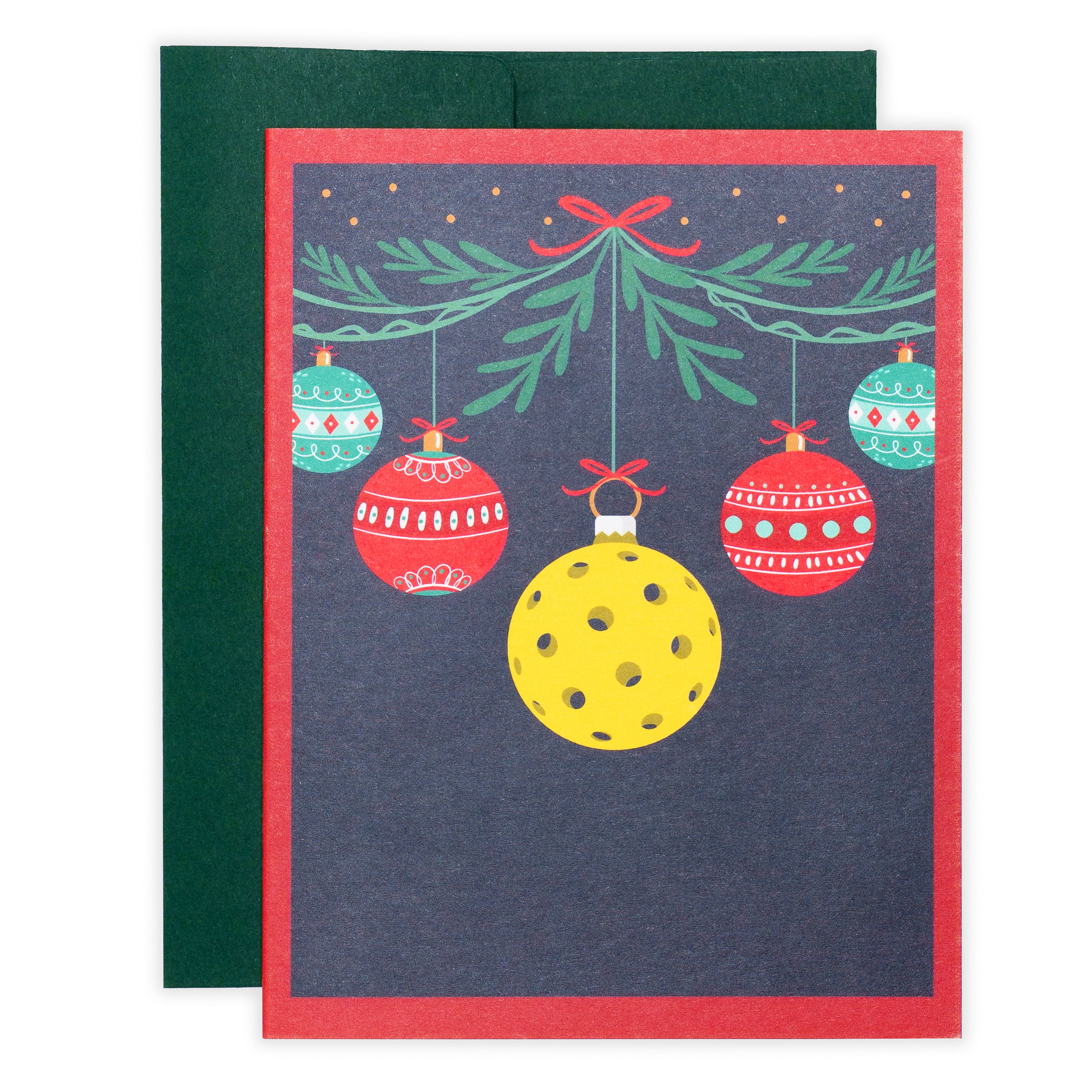 Pickleball themed Christmas greeting card with hanging ornaments and a pickleball with a green envelope laying flat
