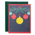 Pickleball themed Christmas greeting card with hanging ornaments and a pickleball with a green envelope laying flat