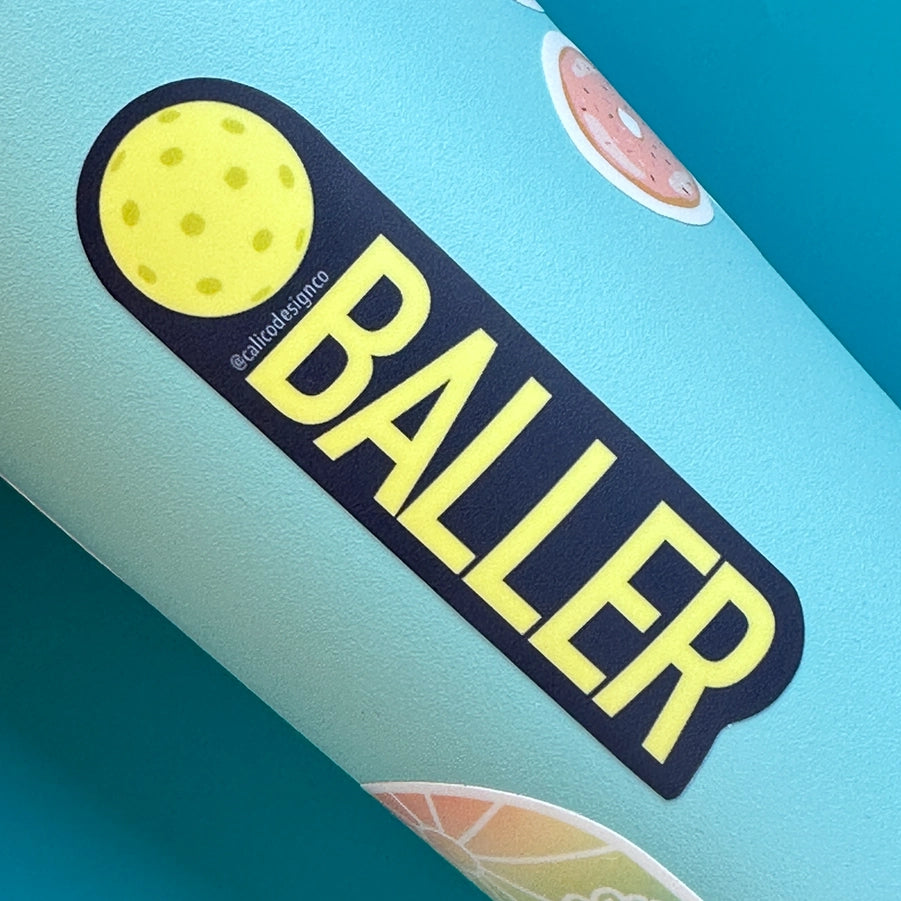 Sticker that has pickleball and says baller on it on a water bottle